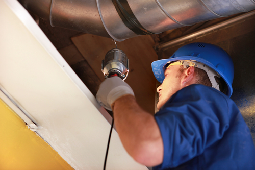 worker examining and estimating attic insulation. towson maryland insulation company